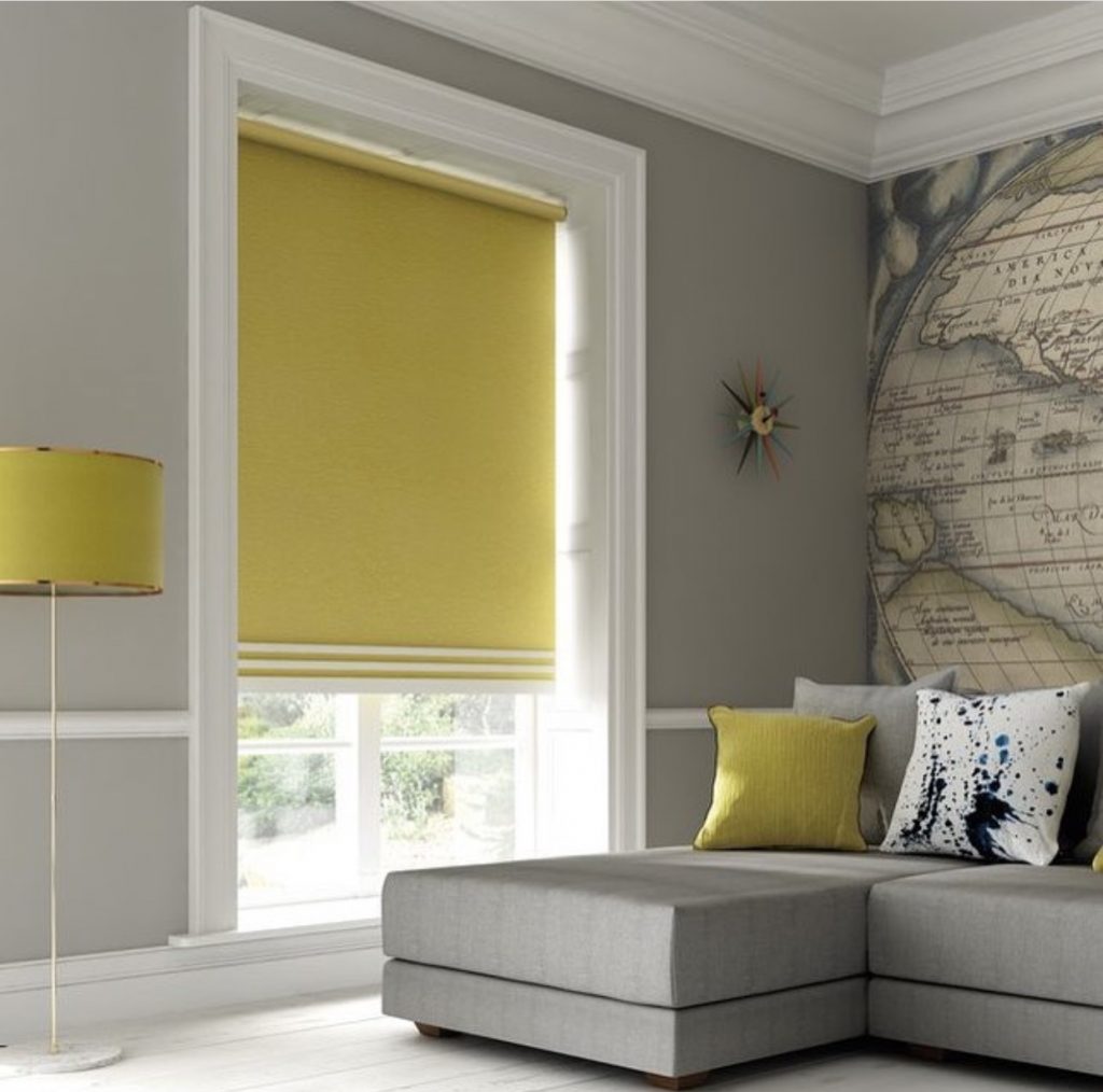 An image showering a mustard yellow roller blind in stylish living room
