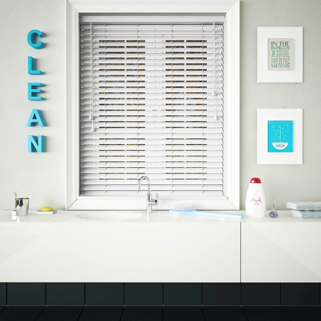 An image showing white wooden blinds fitted in a neutral coloured bathroom